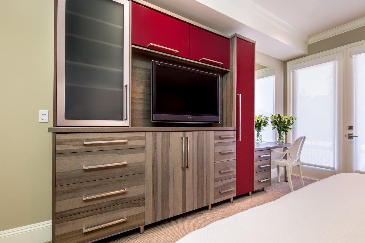 Shinnoki wood veneer cabinets with ruby red acrylic and aluminium framed doors